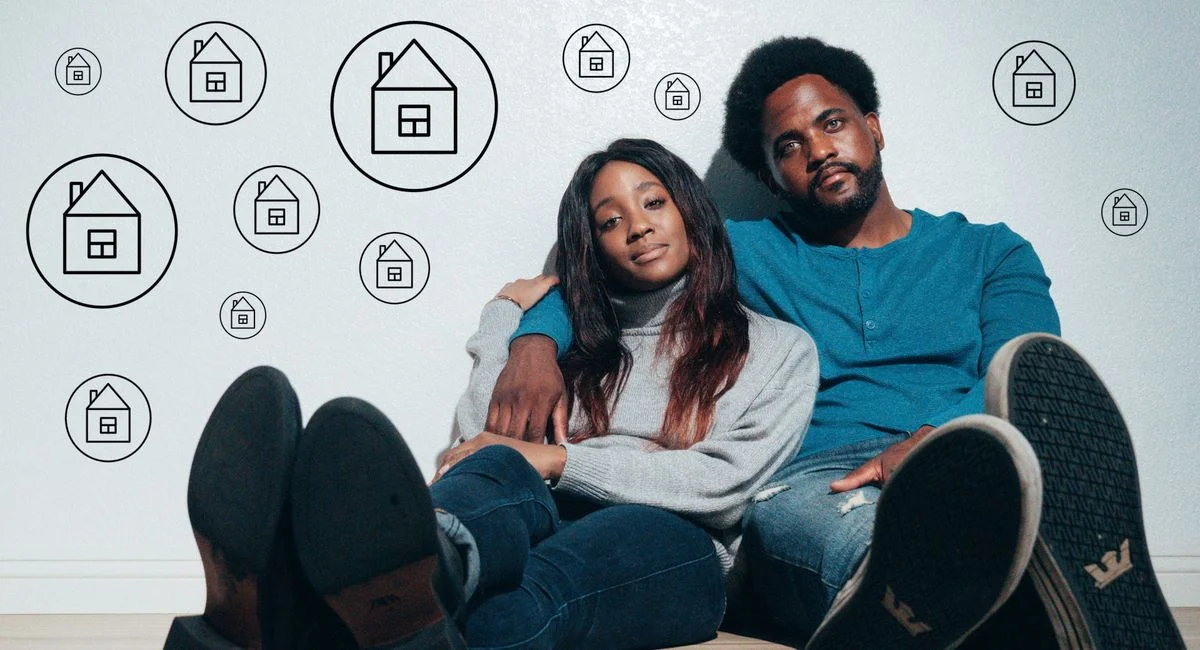 Couple sitting on the floor dreaming about new home ownership surrounded by house icons.