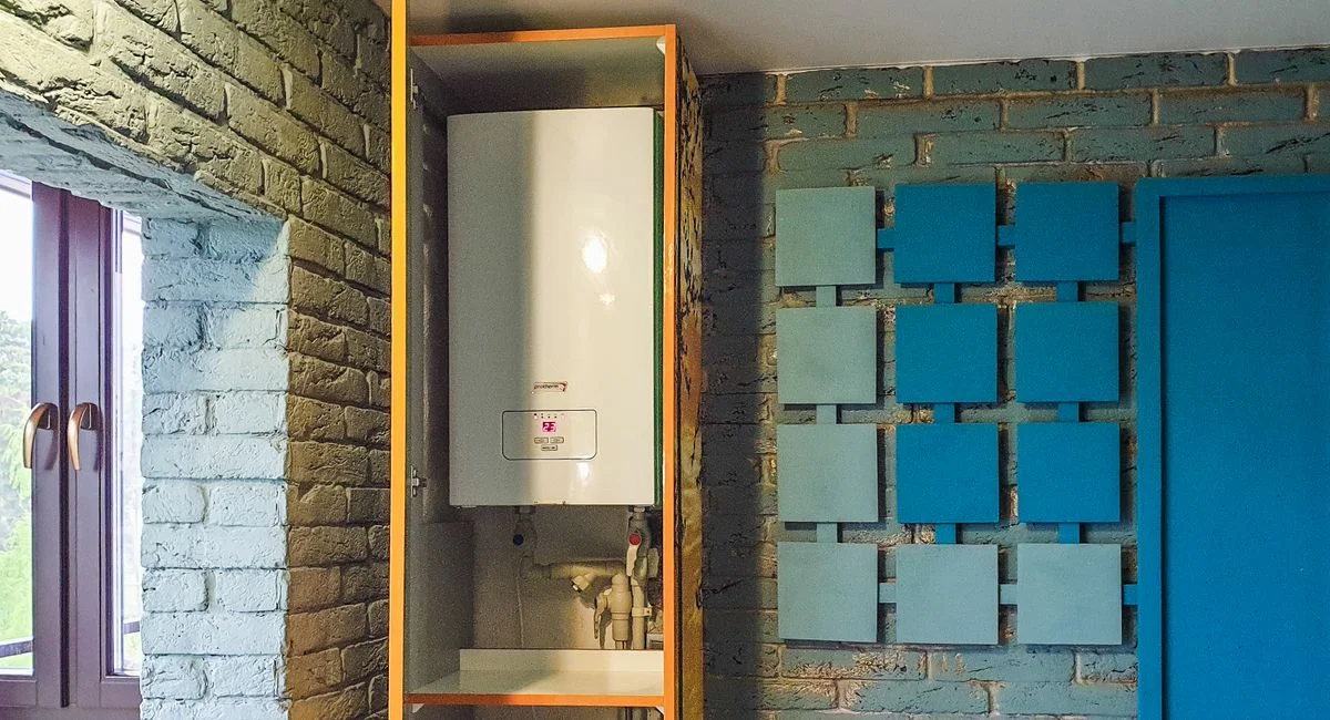 Indoor view of a water heater neatly installed in a cabinet with modern decor.
