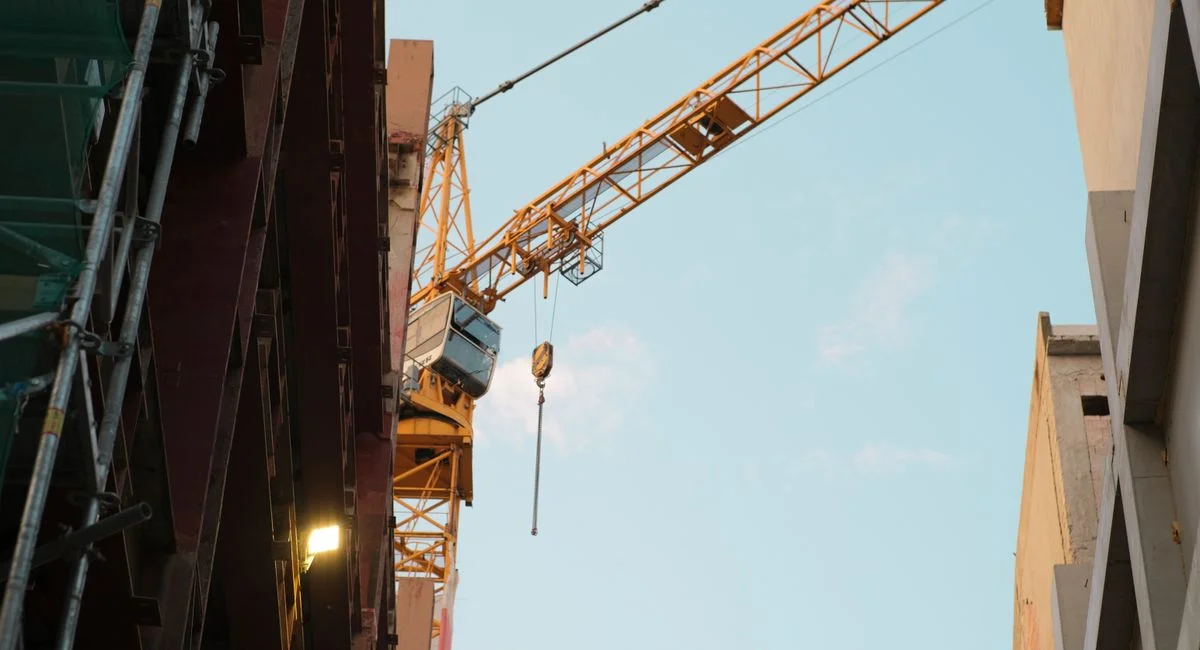 A construction crane dominates the urban skyline of Bratislava, Slovakia.