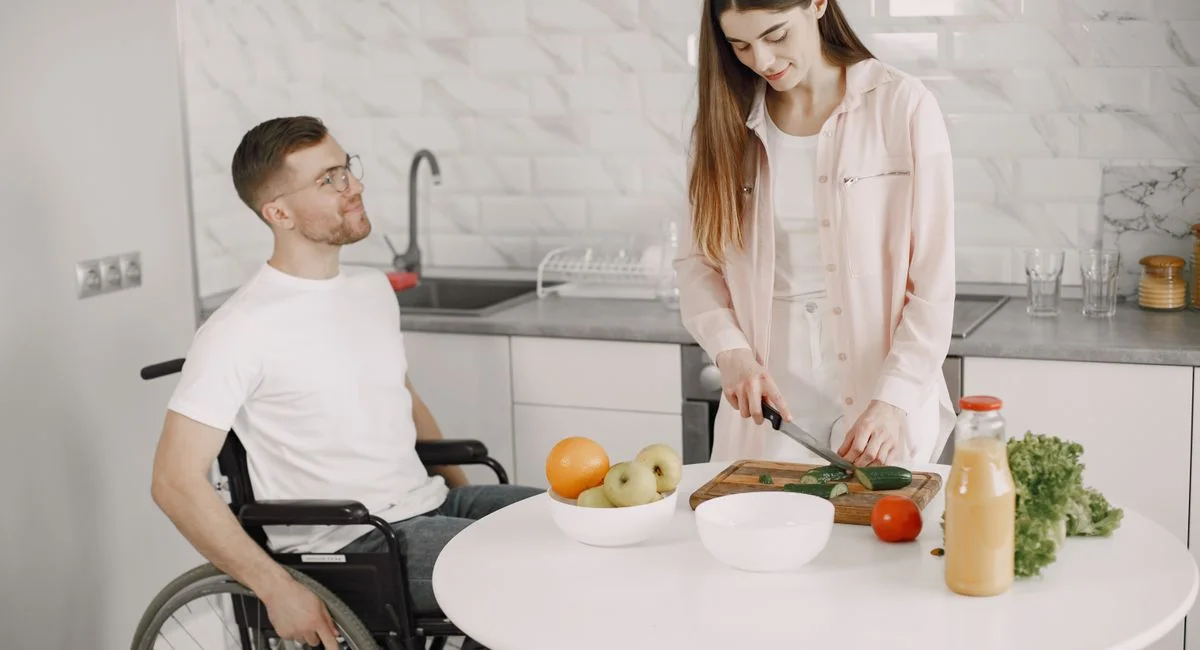A couple cooking together in a modern kitchen, fostering teamwork and joy.