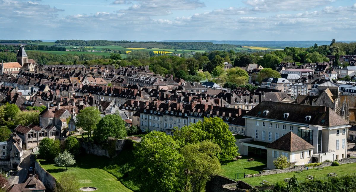 Picturesque aerial view of Falaise in Normandy, featuring historical architecture and lush greenery.