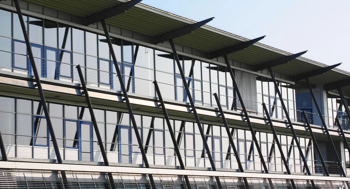 Contemporary office building featuring glass facade and unique architectural design, reflecting modern industry innovation.