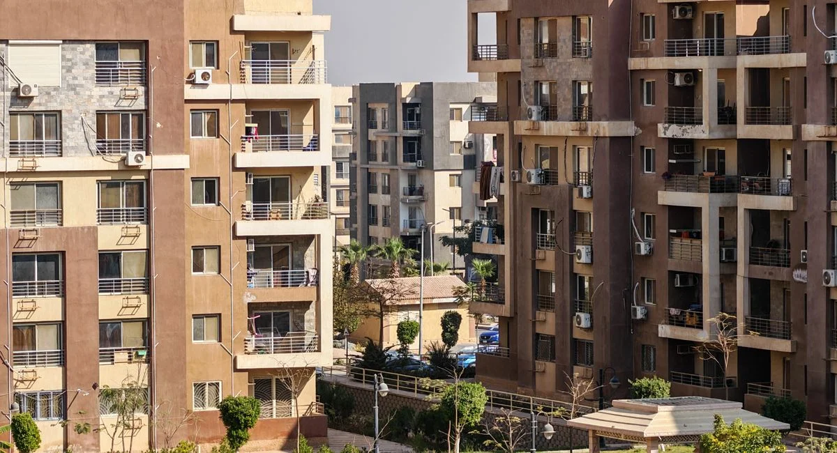 Contemporary apartment buildings with balconies and green spaces captured in daylight.