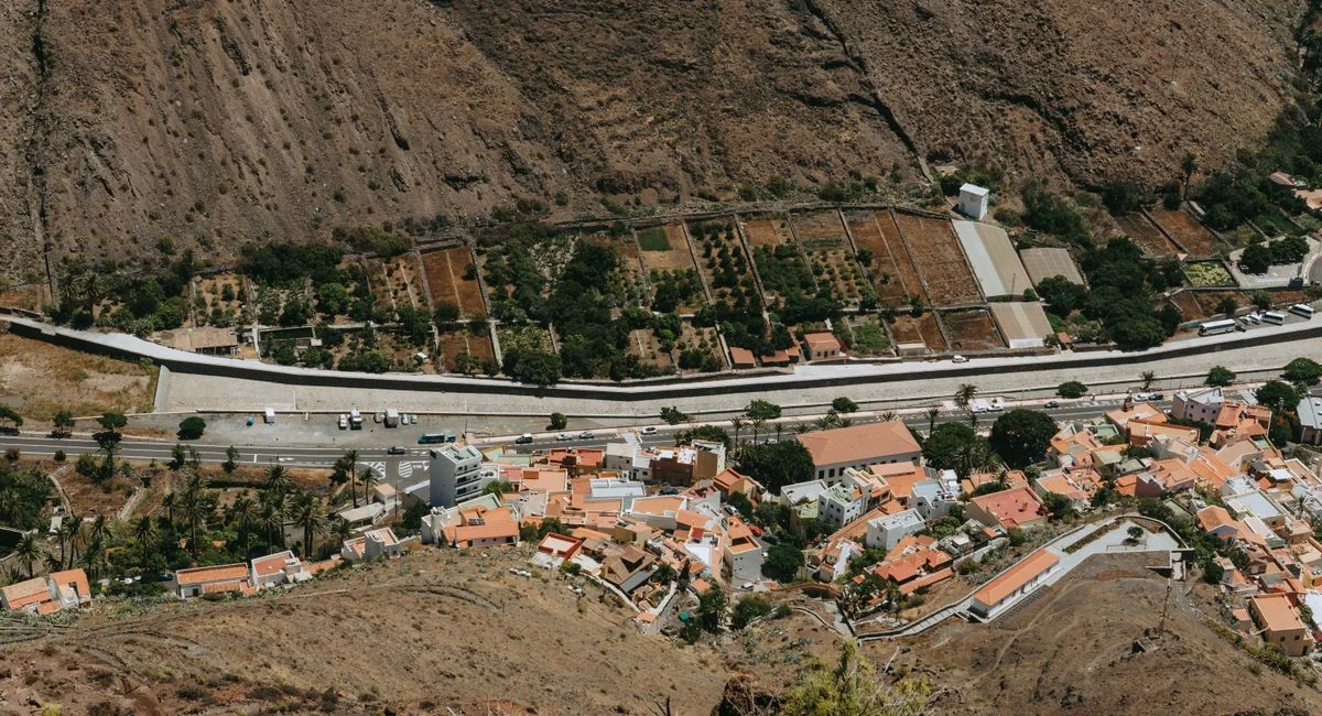 A breathtaking view of Valle Gran Rey featuring terracotta roofed houses and lush gardens.